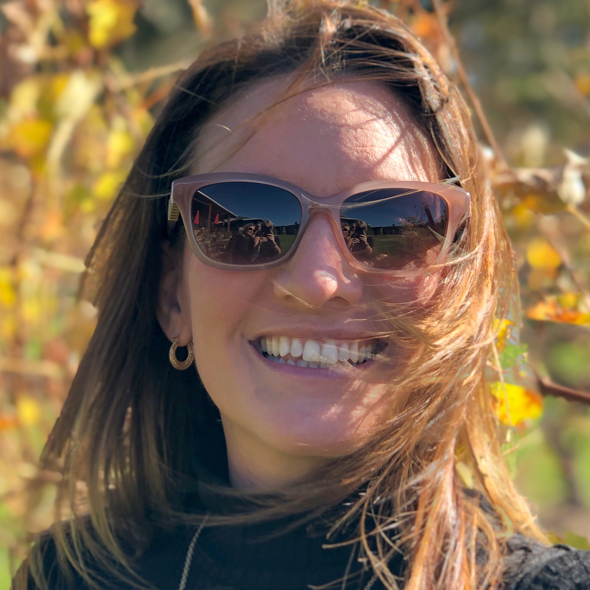TT smiling outdoors in autumn light